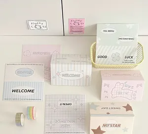 Macro detail of various pastel greeting cards with decorative plaid tapes and wire basket