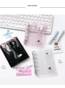 Glittery PVC binder covers in pink, black, and clear with silver metal rings and button