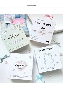 Close-up of four aesthetic mini photocard albums with bow designs and magnetic closures