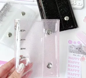 Detailed view of mini PVC three-hole binder covers with glitter finish and snap closure