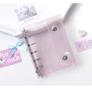 Detail of pink glitter PVC binder cover with silver rings and snap button closure