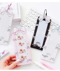 Detail of ballet style acrylic photo card holders with bow designs and wire keychains