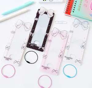 Close-up of acrylic photocard holders with cute bow designs and colored wire keychains