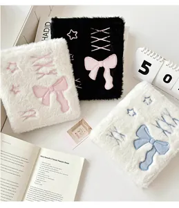 Detail of plush A6 binder covers featuring soft fur texture and ballet bow embroidery