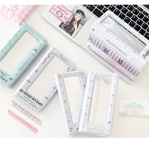Detail of macaron-colored photocard albums with ribbon patterns and transparent windows