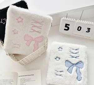 Detail of plush A6 photocard binders with ballet bow embroidery and soft fur texture