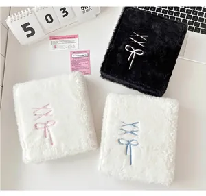 Detailed view of plush A6 photocard binder cover with bow embroidery and soft faux fur texture