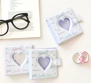 Detalle de mini álbumes de fotos de 3 agujeros con recorte de corazón y lazo ballet