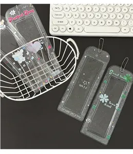 Macro view of transparent glitter PVC card holders with bead chains and clover patterns