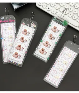 Detailed view of four glittery transparent photo card holders with bead chains and graphics