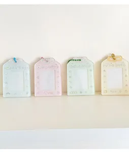 Row of colorful acrylic puppy card holders with bow decorations on a white shelf
