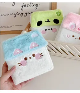 Macro detail of plush house-shaped kpop photocard album with cute animal embroidery