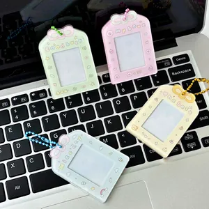 Pastel acrylic card holders with cute bows and bead chains on a laptop keyboard