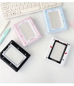 Flat lay of colorful PVC mini photo albums with hollow heart windows on a desk