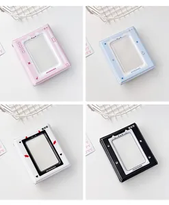 Collection of pixel-style mini photo albums in pink, blue, white, and black colors