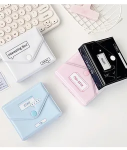 Macro shot of stylish glossy mini card albums in multiple colors with snap button closure
