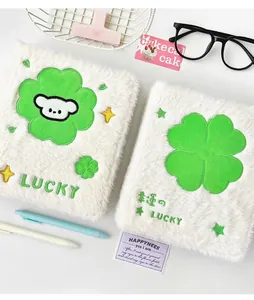 Macro view of plush white A6 photocard holder with clover and lucky embroidery