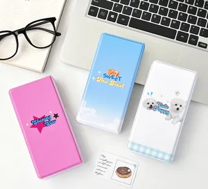 Detail showing colorful cartoon storage cases for idol cards on an office desk setup
