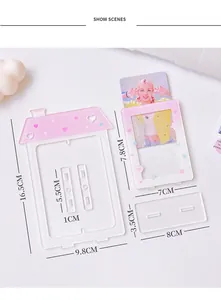 Pink house-shaped acrylic photo frame display with heart and star patterns on desk stand