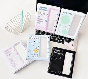 Various cute mini photo albums with transparent cover windows on a white desk setup
