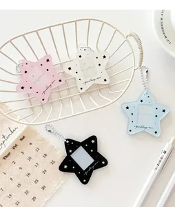 Star pattern acrylic photo card holders in four colors with bead chains on a white desk