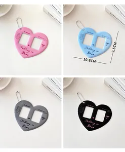 Detail view of heart-shaped double photo card holder with ball chain in four colors