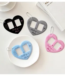 Close-up of heart-shaped photo card holders in four colors with silver bead chains
