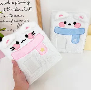 Detail of plush animal photo album featuring embroidery and clear card slot cover