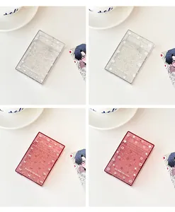 Detailed view of four glitter acrylic photo card holders with star and bow designs