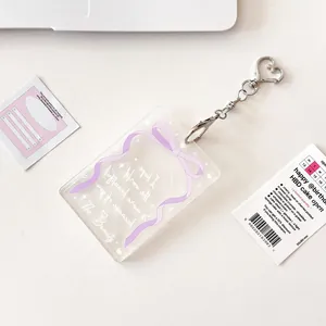 Transparent acrylic card holder with purple bow print and silver heart-shaped metal clasp