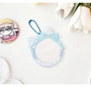 Detail of light blue cat ear lace photocard holder with ribbon and blue bead chain