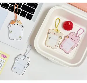 Detail of four acrylic cartoon animal card holders with matching ball chains on a desk