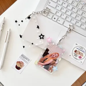 Star-patterned acrylic photocard holder with star-shaped clasp on a laptop keyboard
