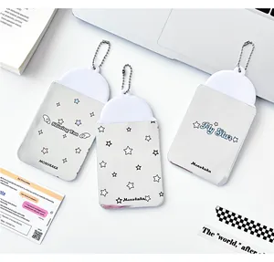 Close-up of star pattern PVC card holders with bead chains on a clean desk