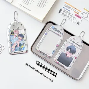 Three silver star photocard holders with bead chains on a decorative tray