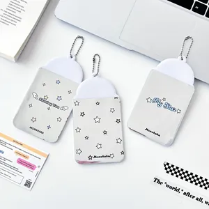 Three-piece set of silver star PVC photo card holders with ball chains on a white desk