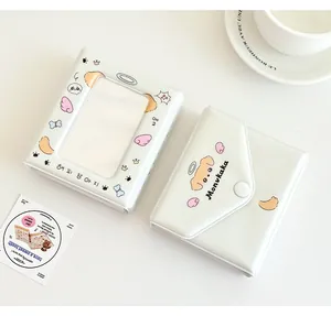 Detailed view of cream-colored cartoon puppy photo card holder and album with flap