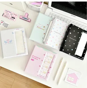 Detailed overhead view of multiple pastel photocard binders on a desktop setup