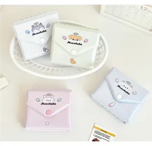 Pastel cartoon pet card holders in four colors displayed on a white decorative tray