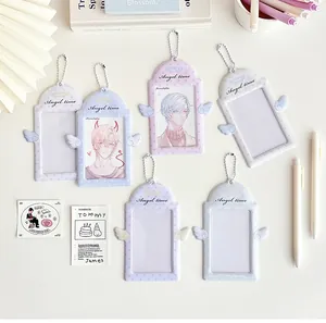 Pastel PVC card holders with angel wings and silver chains shown with deco items