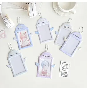 Detail of angel wing PVC photocard holders in four pastel colors with metal chains