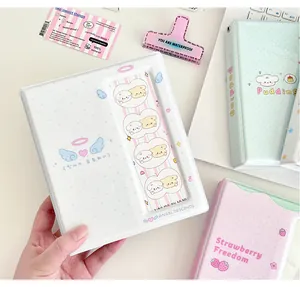 Detail view of the white angel-themed binder with heart wings and a photo slot