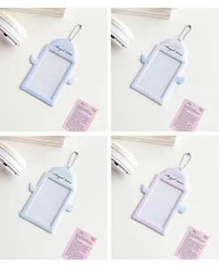 Detail of four colorful Angel Wing PVC card holders with metal chains in a soft pastel aesthetic