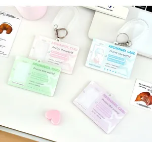 Detail of four candy-colored acrylic card holders with angel wings and spring lanyards