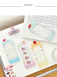 Detail of colorful acrylic card holders featuring 3D dessert charms and animal prints