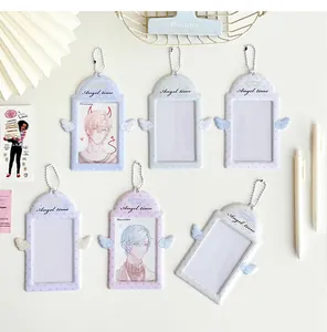 Close-up of angel wing photocard holders with bead chains in assorted pastel colors