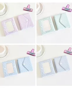 Dettaglio di mini album fotografici color macaron con chiusura a scatto e stelle