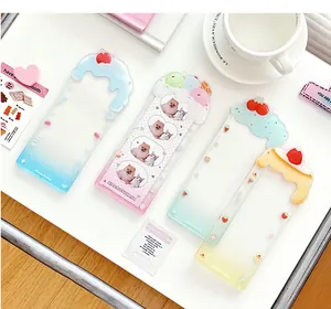 Macro view of clear acrylic four-grid photo card holders with colorful dessert 3D charms