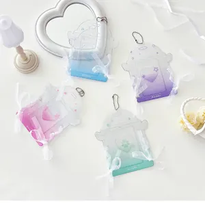 Detail of glitter lace card holders with angel wings and white silk bows in four colors