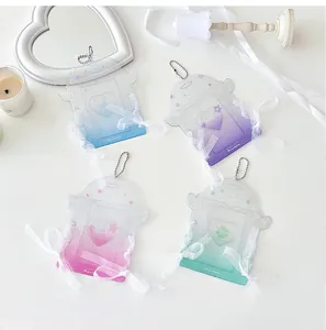 Macro detail of four glittery heart-shaped acrylic photocard holders with lace ribbons